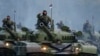 SERBIA-RUSSIA/PUTIN -- Serbian troops salute from the top of their tanks during a military parade to mark 70 years since the city's liberation by the Red Army in Belgrade October 16, 2014.