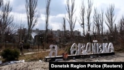 Поврежденный обстрелами знак "Я люблю Авдеевку" в центре города. Фотография сделана 28 марта