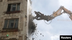 Russia -- An excavator wrecks a building, which is part of the old five-storey apartment blocks demolition project launched by the city authorities, in Moscow, Russia, June 20, 2017