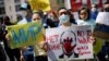 MEXICO – People holding banners attend an anti-war protest outside the Russian Embassy, after Russia launched a massive military operation against Ukraine, in Mexico City, Mexico February 26, 2022