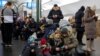 People take shelter inside the metro station during Russian missile attacks in Kyiv